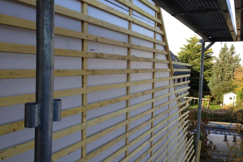 Pose d'un bardage en ardoises naturelles sur pignons